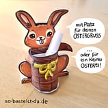Osterhase mit Ostergruß im Korb